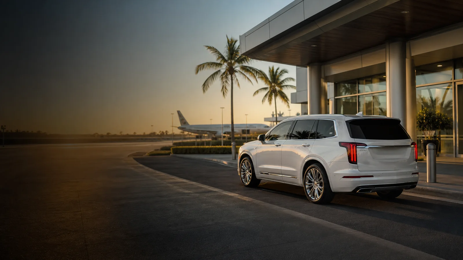 White private SUV arriving at a palm-lined Florida airport terminal